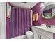 This bathroom features purple walls, a shower with curtain, tile floors, and sink at 337 Scottsdale Sq # 337, Winter Park, FL 32792