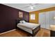 This bedroom has one bed, hardwood floors, neutral and purple walls, and a ceiling fan at 337 Scottsdale Sq # 337, Winter Park, FL 32792