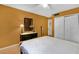 This bedroom features hardwood floors, an orange accent wall and standard closet at 337 Scottsdale Sq # 337, Winter Park, FL 32792