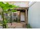 Charming entrance with a white door, lush landscaping, and a cozy, inviting appeal to this lovely home at 337 Scottsdale Sq # 337, Winter Park, FL 32792