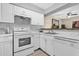 This kitchen features white cabinets, white appliances and tile flooring at 337 Scottsdale Sq # 337, Winter Park, FL 32792