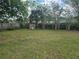 Large backyard with a wooden fence creating a secure and private space for outdoor enjoyment at 4506 Se 7Th Pl, Ocala, FL 34471