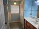 Cozy bathroom featuring a vanity with wood cabinets and a combination shower and tub at 4506 Se 7Th Pl, Ocala, FL 34471