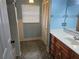 Cozy bathroom featuring a vanity with wood cabinets and a combination shower and tub at 4506 Se 7Th Pl, Ocala, FL 34471