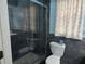 This bathroom features blue tile, a glass shower door, and modern fixtures at 4506 Se 7Th Pl, Ocala, FL 34471