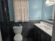 Modern bathroom features blue walls, a stylish vanity, updated toilet and fixtures at 4506 Se 7Th Pl, Ocala, FL 34471