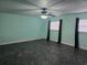A spacious bedroom with unique flooring, ceiling fan and natural light from two windows at 4506 Se 7Th Pl, Ocala, FL 34471