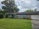 Charming single-story brick home with blue shutters, well-maintained lawn, and mature shade trees at 4506 Se 7Th Pl, Ocala, FL 34471
