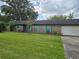 Charming single-story brick home with blue shutters, well-maintained lawn, and mature shade trees at 4506 Se 7Th Pl, Ocala, FL 34471