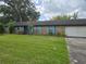 Charming single-story brick home with blue shutters, well-maintained lawn, and mature shade trees at 4506 Se 7Th Pl, Ocala, FL 34471