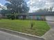Charming single story home with a well-maintained lawn, blue shutters, and attached garage at 4506 Se 7Th Pl, Ocala, FL 34471