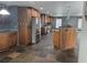 Well-lit kitchen with a stainless steel refrigerator, custom cabinetry, granite counters, and slate floors at 4506 Se 7Th Pl, Ocala, FL 34471