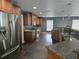 Renovated kitchen with granite counters, stainless steel appliances, custom wood cabinetry, and slate flooring at 4506 Se 7Th Pl, Ocala, FL 34471