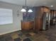 Bright kitchen with granite counters, stainless steel refrigerator, custom cabinetry, and slate floors at 4506 Se 7Th Pl, Ocala, FL 34471
