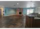 Spacious living room featuring a brick fireplace, tile flooring, and views of the backyard at 4506 Se 7Th Pl, Ocala, FL 34471