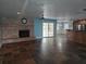 Open living room features a brick fireplace, ceiling fan, and sliding glass doors at 4506 Se 7Th Pl, Ocala, FL 34471