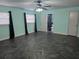 Spacious bedroom with unique flooring, ceiling fan, natural light, and bathroom access at 4506 Se 7Th Pl, Ocala, FL 34471
