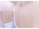 Bright bathroom with a bathtub featuring a shower and white shower curtain and a towel bar at 14791 Sw 29Th Avenue Rd, Ocala, FL 34473