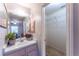 Bathroom with a view to walk-in closet, featuring a single vanity and a well-lit mirror at 14791 Sw 29Th Avenue Rd, Ocala, FL 34473