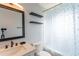 Bathroom features a shower, toilet, vanity, shelves, and mirror at 14791 Sw 29Th Avenue Rd, Ocala, FL 34473