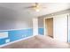 Spacious bedroom featuring ceiling fan and closet with shelving at 14791 Sw 29Th Avenue Rd, Ocala, FL 34473