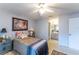 Charming bedroom featuring soothing paint tones, ceiling fan, and ensuite bathroom access for added convenience at 14791 Sw 29Th Avenue Rd, Ocala, FL 34473