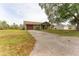Charming single-story home with a well-maintained lawn and a concrete driveway leading to the garage at 14791 Sw 29Th Avenue Rd, Ocala, FL 34473