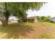 Charming single-story home with mature trees in the front yard, featuring a well-maintained lawn at 14791 Sw 29Th Avenue Rd, Ocala, FL 34473