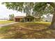 Charming single-story home with an attached garage and a large front yard shaded by mature trees at 14791 Sw 29Th Avenue Rd, Ocala, FL 34473