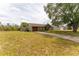 Single-story home with a brown garage door, a quaint front porch, and an expansive front yard at 14791 Sw 29Th Avenue Rd, Ocala, FL 34473