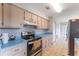View of the kitchen with light wood cabinets and updated stainless steel oven range at 14791 Sw 29Th Avenue Rd, Ocala, FL 34473