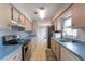 Galley kitchen featuring blonde wood cabinets, stainless steel appliances, and blue countertops at 14791 Sw 29Th Avenue Rd, Ocala, FL 34473