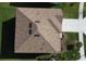 Aerial view of a well-maintained home featuring a brown shingle roof and manicured landscaping at 3387 Tawny Grove Pl, Lakeland, FL 33811
