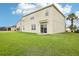 Spacious, green backyard with a neutral home exterior, patio, and lush landscaping at 3387 Tawny Grove Pl, Lakeland, FL 33811