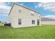 Large, well-maintained backyard with lush green grass and a neutral-toned home exterior at 3387 Tawny Grove Pl, Lakeland, FL 33811