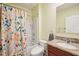 Well-lit bathroom featuring a tub, granite countertop, and colorful shower curtain at 3387 Tawny Grove Pl, Lakeland, FL 33811
