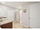 Bright bathroom featuring a double sink vanity, shower with curtain, tile floors, and neutral walls at 3387 Tawny Grove Pl, Lakeland, FL 33811