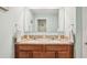 Bathroom vanity with double sinks, granite countertop, and a large mirror for a bright and modern space at 3387 Tawny Grove Pl, Lakeland, FL 33811