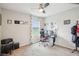 Bright bedroom with a ceiling fan, large window overlooking the neighborhood lake, and neutral carpet at 3387 Tawny Grove Pl, Lakeland, FL 33811