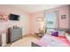 Charming bedroom with a pink accent wall and bright window at 3387 Tawny Grove Pl, Lakeland, FL 33811