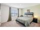 Cozy bedroom with a comfortable bed, large window and calm, neutral decor at 3387 Tawny Grove Pl, Lakeland, FL 33811