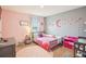 Cozy bedroom with a pink accent wall, window, and a cute bed setup at 3387 Tawny Grove Pl, Lakeland, FL 33811
