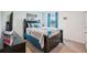 Bedroom with a queen-size bed, a dark wood dresser, and a window overlooking the outdoor landscape at 3387 Tawny Grove Pl, Lakeland, FL 33811