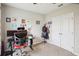 The bedroom features neutral walls, carpet flooring, and is decorated with colorful photos and artwork at 3387 Tawny Grove Pl, Lakeland, FL 33811