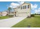 Two-story home featuring a two-car garage, well-kept lawn, and ample driveway space at 3387 Tawny Grove Pl, Lakeland, FL 33811