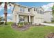 Charming two-story home with a well-manicured lawn and beautiful landscaping at 3387 Tawny Grove Pl, Lakeland, FL 33811