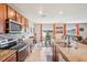 Open kitchen with granite countertops, stainless steel appliances, and eat in kitchen with lake view at 3387 Tawny Grove Pl, Lakeland, FL 33811