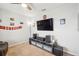 Well-lit living room featuring entertainment center, ceiling fan and ample space for lounging at 3387 Tawny Grove Pl, Lakeland, FL 33811