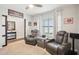 Comfortable living room featuring recliners, ceiling fan, and a large window for natural light at 3387 Tawny Grove Pl, Lakeland, FL 33811