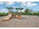 Charming playground with slides, swings, and a secure, wood-chip ground for safety at 3387 Tawny Grove Pl, Lakeland, FL 33811